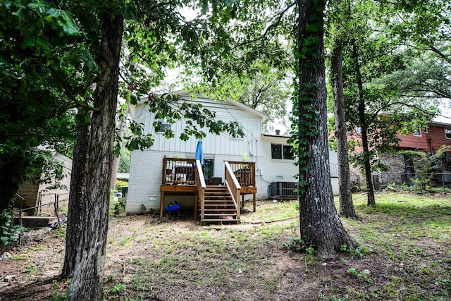 back of house featuring stairway, brick siding, a deck, and cooling unit