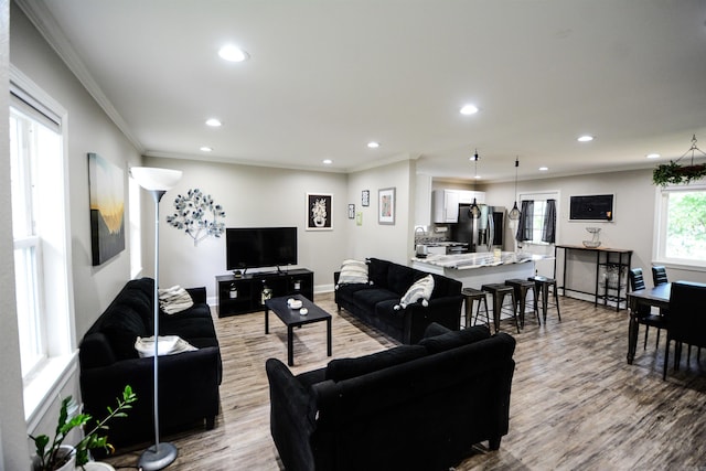 living room with recessed lighting, ornamental molding, wood finished floors, and baseboards