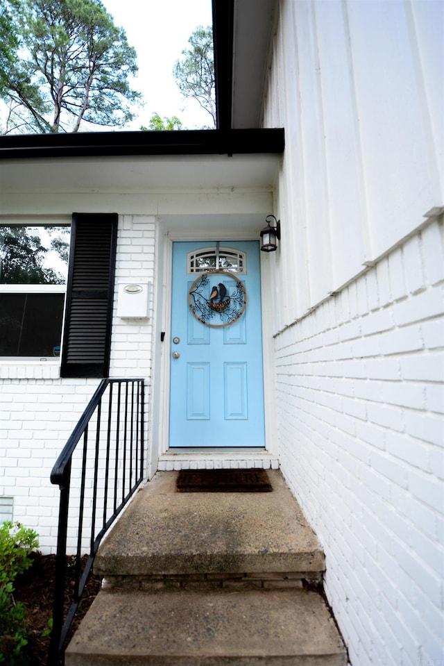 doorway to property with brick siding