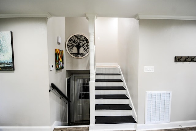 stairs featuring baseboards and crown molding