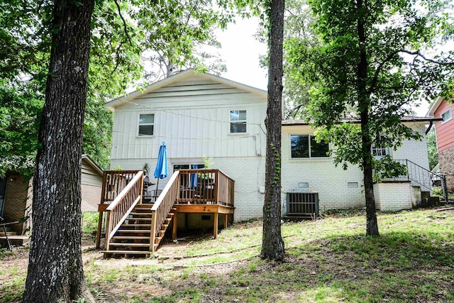 rear view of house with stairs, brick siding, central AC unit, a deck, and crawl space