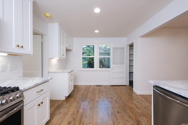 700 N Taylor St, Little Rock, AR 72205 - kitchen with stainless steel appliances, light stone counters, light wood-style floors, white cabinetry, and recessed lighting