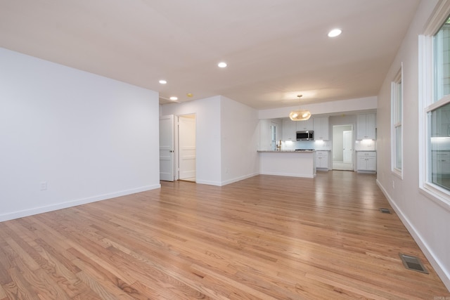 700 N Taylor St, Little Rock, AR 72205 - unfurnished living room featuring light wood-style flooring, recessed lighting, and baseboards