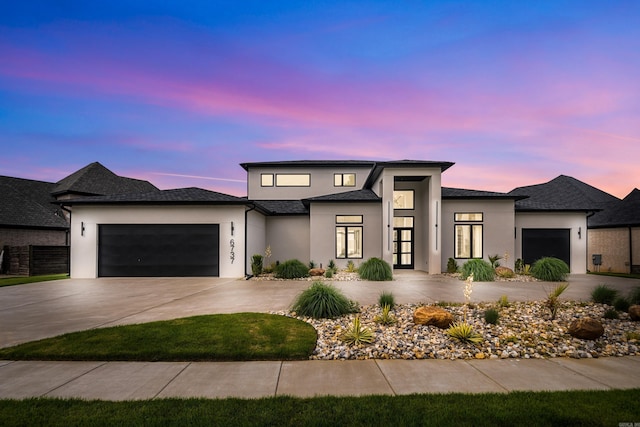 6737 Hilo Ave, Benton, AR 72019 - view of front of house featuring a garage, stucco siding, and concrete driveway