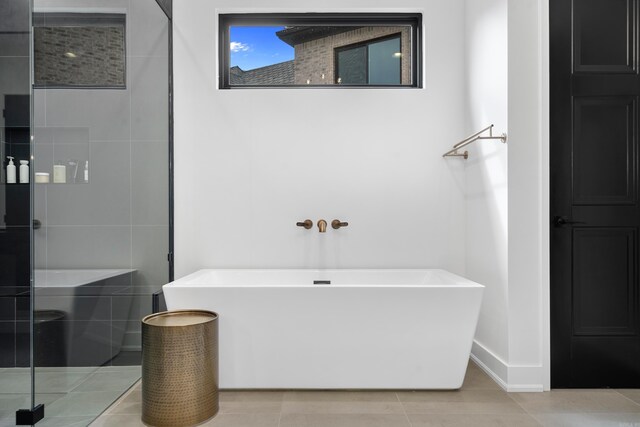 6737 Hilo Ave, Benton, AR 72019 - full bath with a freestanding tub, a shower stall, baseboards, and tile patterned floors