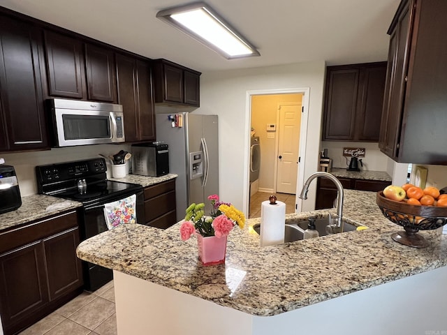 1056 Skyline Dr, Alexander, AR 72002 - kitchen featuring appliances with stainless steel finishes, light tile patterned floors, light stone countertops, a sink, and dark brown cabinetry