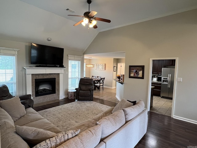 1056 Skyline Dr, Alexander, AR 72002 - living area featuring ceiling fan, baseboards, a tile fireplace, high vaulted ceiling, and wood finished floors