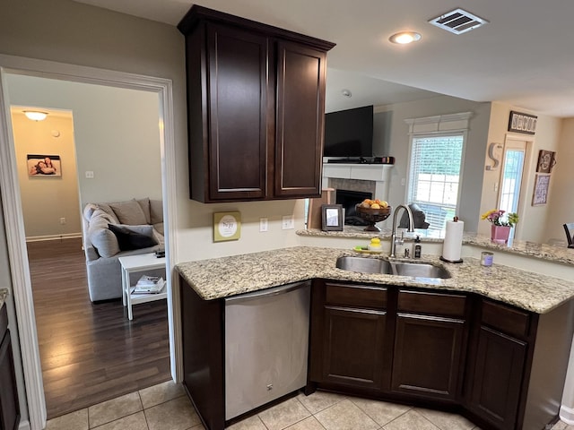1056 Skyline Dr, Alexander, AR 72002 - kitchen featuring a sink, stainless steel dishwasher, open floor plan, dark brown cabinetry, and light stone countertops
