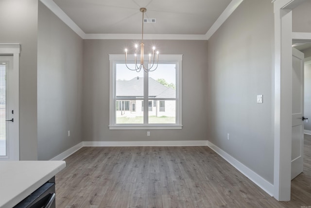 11 Brixton, Cabot, AR 72023 - unfurnished dining area featuring a chandelier, wood finished floors, baseboards, and ornamental molding