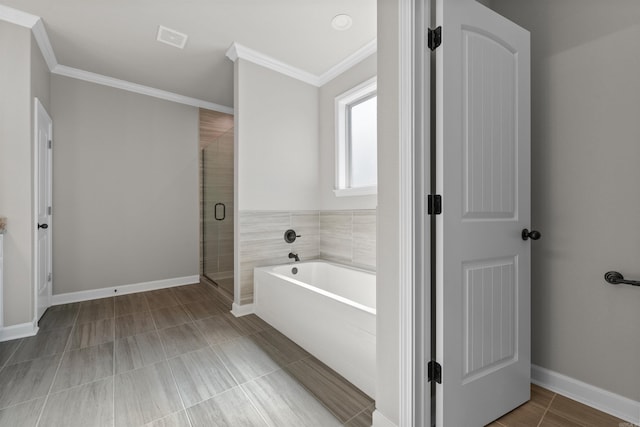 10114 Hidden Cir, Sherwood, AR 72120 - bathroom with a garden tub, crown molding, a shower stall, and baseboards