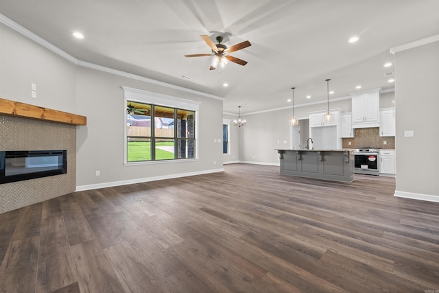 10114 Hidden Cir, Sherwood, AR 72120 - unfurnished living room featuring ceiling fan, a chandelier, recessed lighting, crown molding, and a tile fireplace