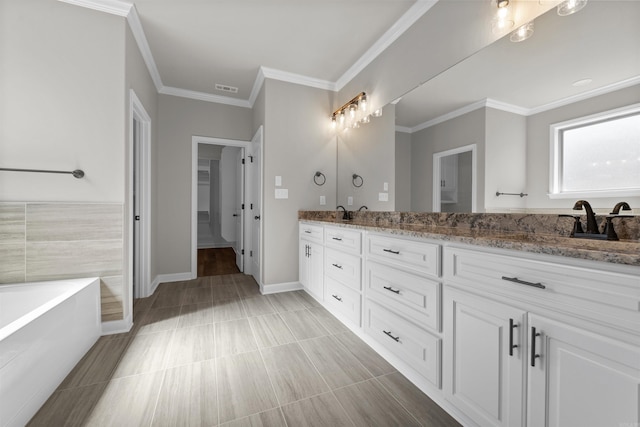 10114 Hidden Cir, Sherwood, AR 72120 - full bathroom with double vanity, a tub, crown molding, baseboards, and a walk in closet
