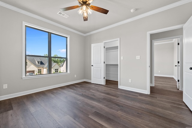 10114 Hidden Cir, Sherwood, AR 72120 - unfurnished bedroom with ornamental molding, dark wood-style floors, baseboards, a walk in closet, and a ceiling fan