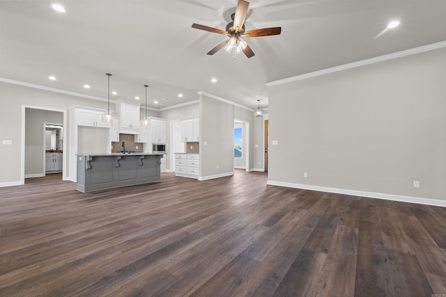 10114 Hidden Cir, Sherwood, AR 72120 - unfurnished living room featuring ceiling fan, a sink, ornamental molding, recessed lighting, and dark wood finished floors