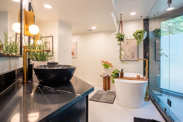 10119 Garrison Rd, Little Rock, AR 72223 - full bathroom with a shower stall, double vanity, a freestanding bath, recessed lighting, and baseboards