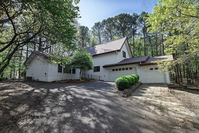 21 Constantina Cir, Hot Springs Village, AR 71909 - view of front of house featuring an attached garage, asphalt driveway, and a shingled roof