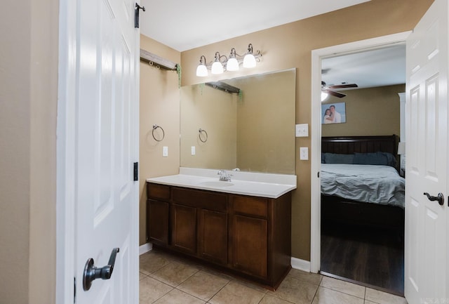 3961 Mountaincrest Cir, Alexander, AR 72002 - bathroom featuring tile patterned flooring, a ceiling fan, vanity, connected bathroom, and baseboards