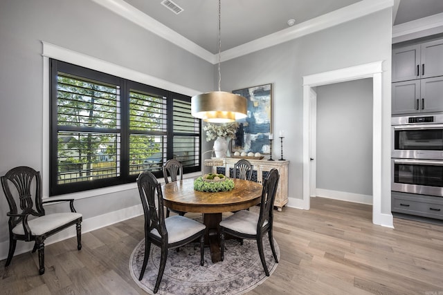 11 Haywood Ct, Little Rock, AR 72223 - dining area featuring crown molding, light wood finished floors, and baseboards