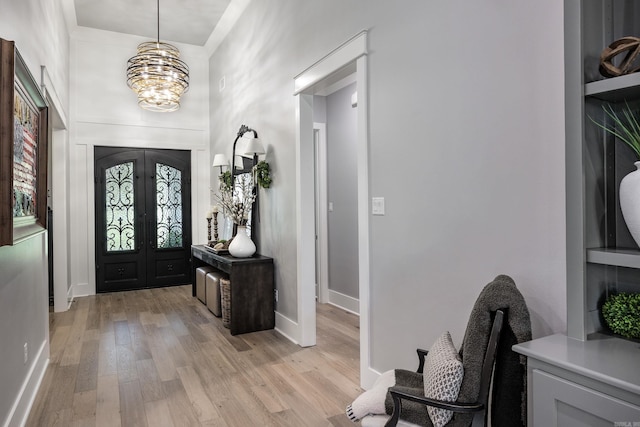 11 Haywood Ct, Little Rock, AR 72223 - entryway featuring light wood finished floors, baseboards, a chandelier, and french doors