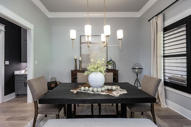11 Haywood Ct, Little Rock, AR 72223 - dining space with ornamental molding, wood finished floors, a chandelier, and baseboards