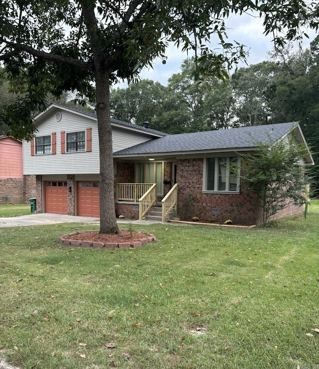 tri-level home featuring brick siding, an attached garage, concrete driveway, and a front lawn