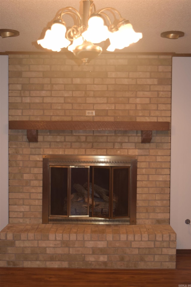 206 Beaconsfield Rd, Sherwood, AR 72120 - detailed view of a chandelier, wood finished floors, and a textured ceiling