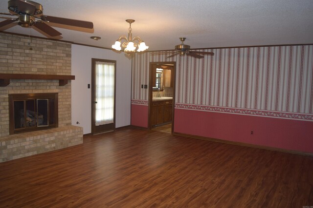 206 Beaconsfield Rd, Sherwood, AR 72120 - unfurnished living room featuring ceiling fan, dark wood-style flooring, a fireplace, wallpapered walls, and baseboards