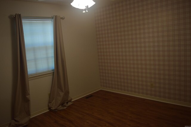 206 Beaconsfield Rd, Sherwood, AR 72120 - empty room with wood finished floors, baseboards, healthy amount of natural light, ceiling fan, and wallpapered walls