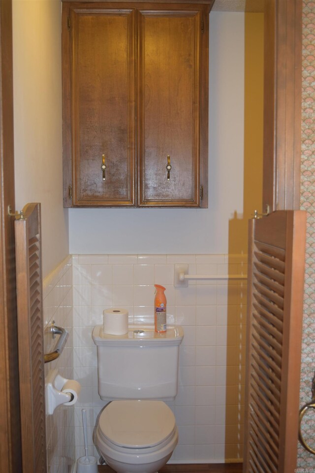 206 Beaconsfield Rd, Sherwood, AR 72120 - bathroom featuring toilet, tile walls, and a wainscoted wall