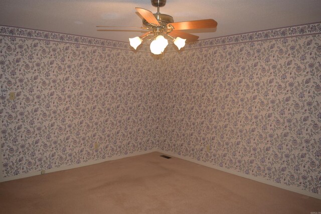 206 Beaconsfield Rd, Sherwood, AR 72120 - carpeted empty room with wallpapered walls, a ceiling fan, and baseboards
