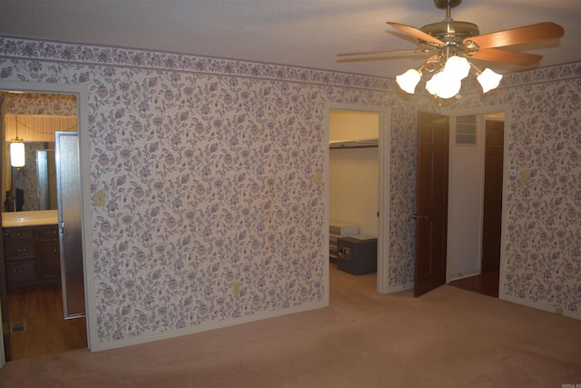 206 Beaconsfield Rd, Sherwood, AR 72120 - unfurnished bedroom with wallpapered walls, carpet flooring, a walk in closet, ensuite bathroom, and a closet