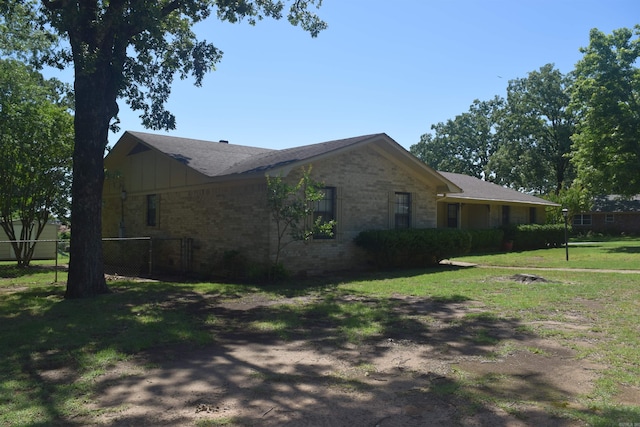 206 Beaconsfield Rd, Sherwood, AR 72120 - view of property exterior featuring brick siding and a shingled roof