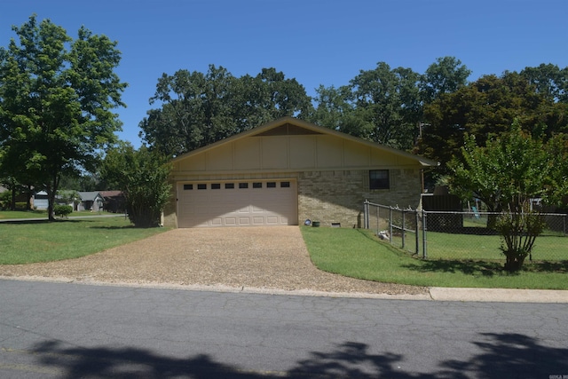 206 Beaconsfield Rd, Sherwood, AR 72120 - view of front of home with board and batten siding, driveway, an attached garage, and brick siding