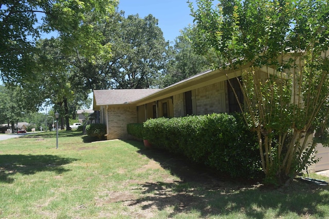 206 Beaconsfield Rd, Sherwood, AR 72120 - view of side of home featuring a lawn and brick siding