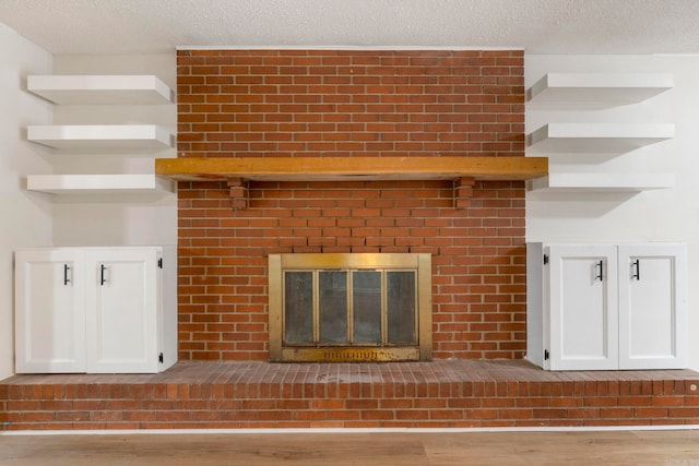 605 N W St, Morrilton, AR 72110 - detailed view of a fireplace, wood finished floors, and a textured ceiling