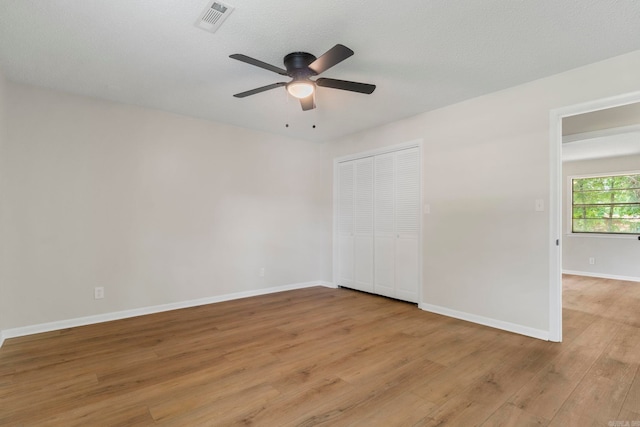 605 N W St, Morrilton, AR 72110 - unfurnished bedroom with light wood-style flooring, baseboards, a closet, and a ceiling fan