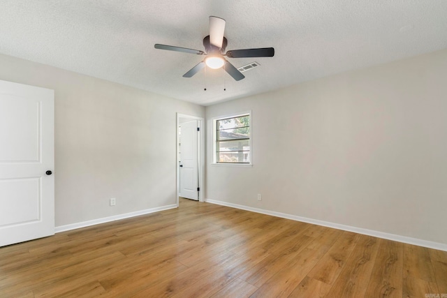 605 N W St, Morrilton, AR 72110 - empty room featuring a ceiling fan, light wood-style flooring, baseboards, and a textured ceiling