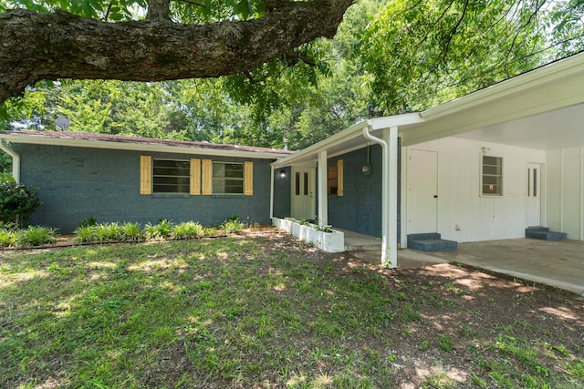 605 N W St, Morrilton, AR 72110 - view of front of property featuring brick siding and an attached carport