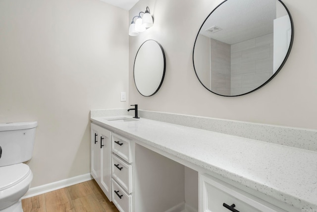 605 N W St, Morrilton, AR 72110 - bathroom with toilet, wood finished floors, vanity, and baseboards