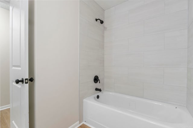 605 N W St, Morrilton, AR 72110 - full bathroom featuring baseboards, bathing tub / shower combination, and wood finished floors