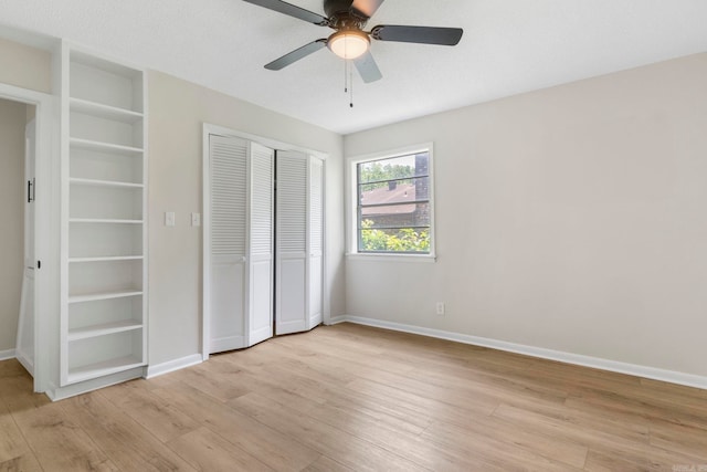 605 N W St, Morrilton, AR 72110 - unfurnished bedroom with light wood-style floors, a closet, baseboards, and ceiling fan