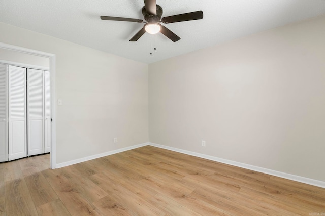 605 N W St, Morrilton, AR 72110 - unfurnished bedroom with light wood finished floors, baseboards, and ceiling fan