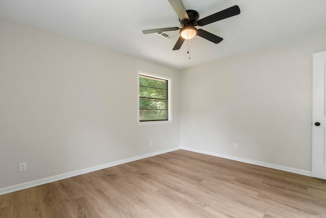605 N W St, Morrilton, AR 72110 - spare room featuring light wood-style flooring, ceiling fan, and baseboards