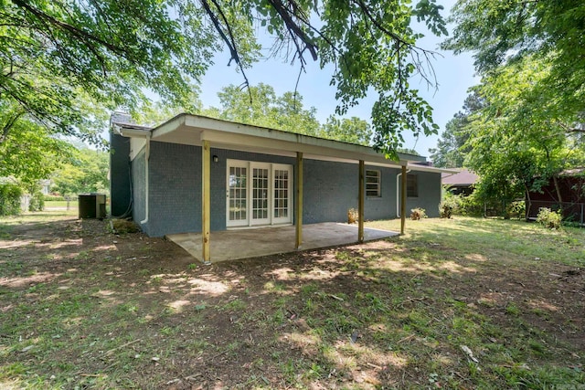 605 N W St, Morrilton, AR 72110 - back of house with a patio, french doors, a chimney, and brick siding