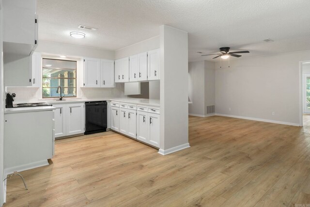 605 N W St, Morrilton, AR 72110 - kitchen with black dishwasher, a ceiling fan, tasteful backsplash, a sink, and white cabinetry