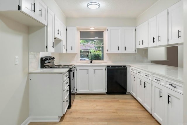 605 N W St, Morrilton, AR 72110 - kitchen with black dishwasher, electric stove, a sink, white cabinets, and light wood finished floors