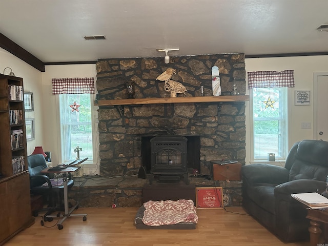 99 Heritage Hl, Higden, AR 72067 - living area with wood finished floors, a wood stove, and ornamental molding