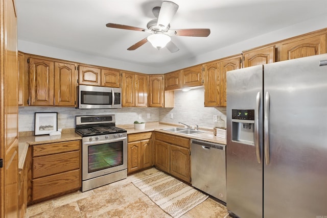 10626 Pineview Dr, Mabelvale, AR 72103 - kitchen with stainless steel appliances, a sink, decorative backsplash, and light countertops