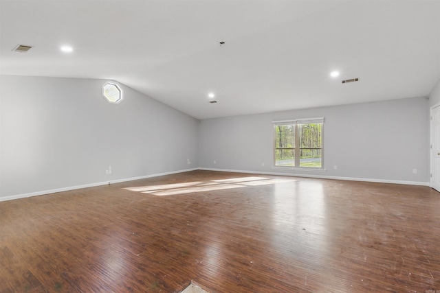 10626 Pineview Dr, Mabelvale, AR 72103 - empty room with lofted ceiling, wood finished floors, baseboards, and recessed lighting