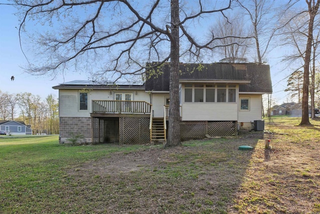 10626 Pineview Dr, Mabelvale, AR 72103 - back of house featuring a deck, a sunroom, a lawn, central AC, and a shingled roof